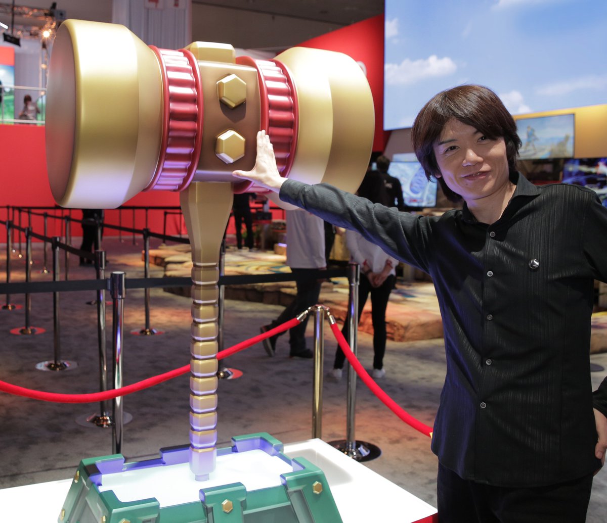 NintendoAmerica's tweet image. Smash Bros. creator Mr. Sakurai poses with a few items from the new Super #SmashBrosUltimate in the #Nintendo #E32018 booth!