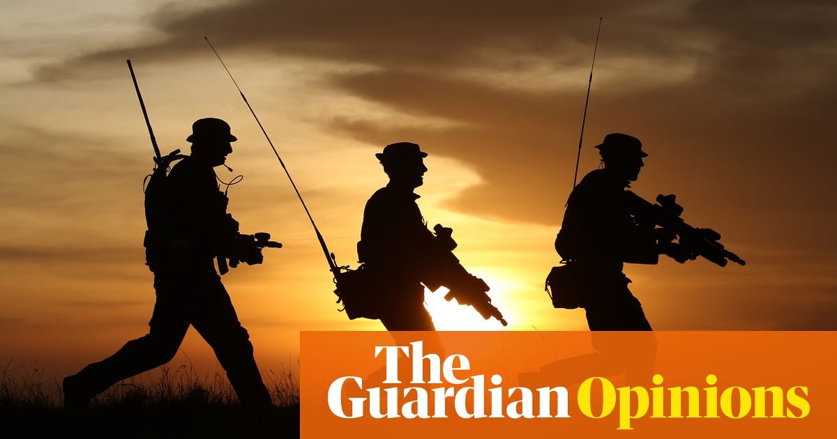 Soldiers walking single file silhouetted against a beautiful dawn or dusk sky