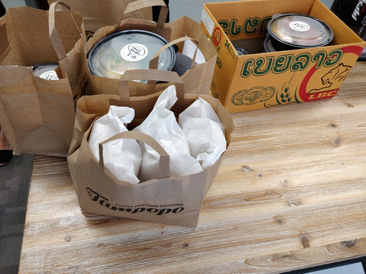 affirmative's tweet photo. Dan is eyeing up the food and who can blame him! 
We treated the team to a delicious lunch from @TampopoEats 
What better way to end the week than with some tasty food?
#TheAffirmativeWay #Bridging #Development #food #companyculture https://t.co/lsvWMChjgN