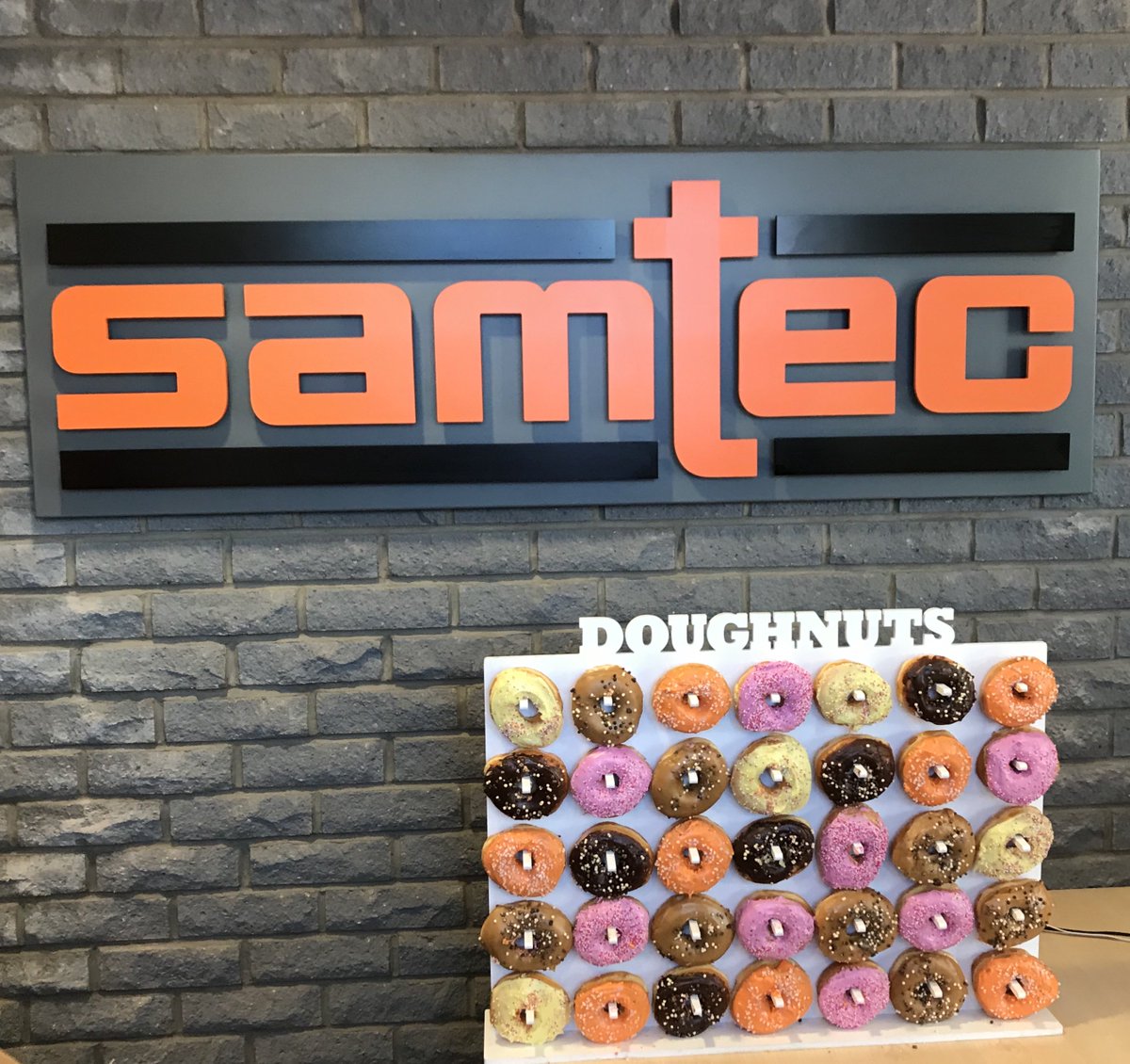 WorkAtSamtec's tweet photo. @SamtecInc - #SamtecScotland was victorious today in a local radio show in #Glasgow!  Their prize was 80 donuts supplied by @McGheesBakery #donutwall! #SamtecLife!  @1025Clyde1.  I can say for a fact that not all 80 donuts were consumed by the crew! https://t.co/JkMNyyLQE8