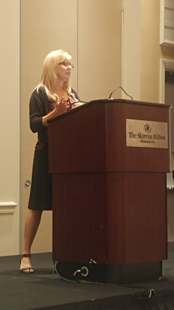 Lainie speaking at the podium.