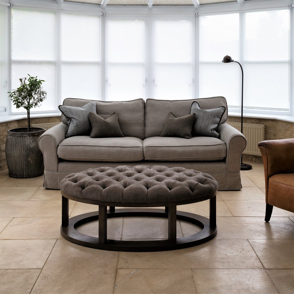 Relaxed conservatory setting, well shaded with Appeal Blinds and comfy sofa and footstool by Pippa Paton Design
