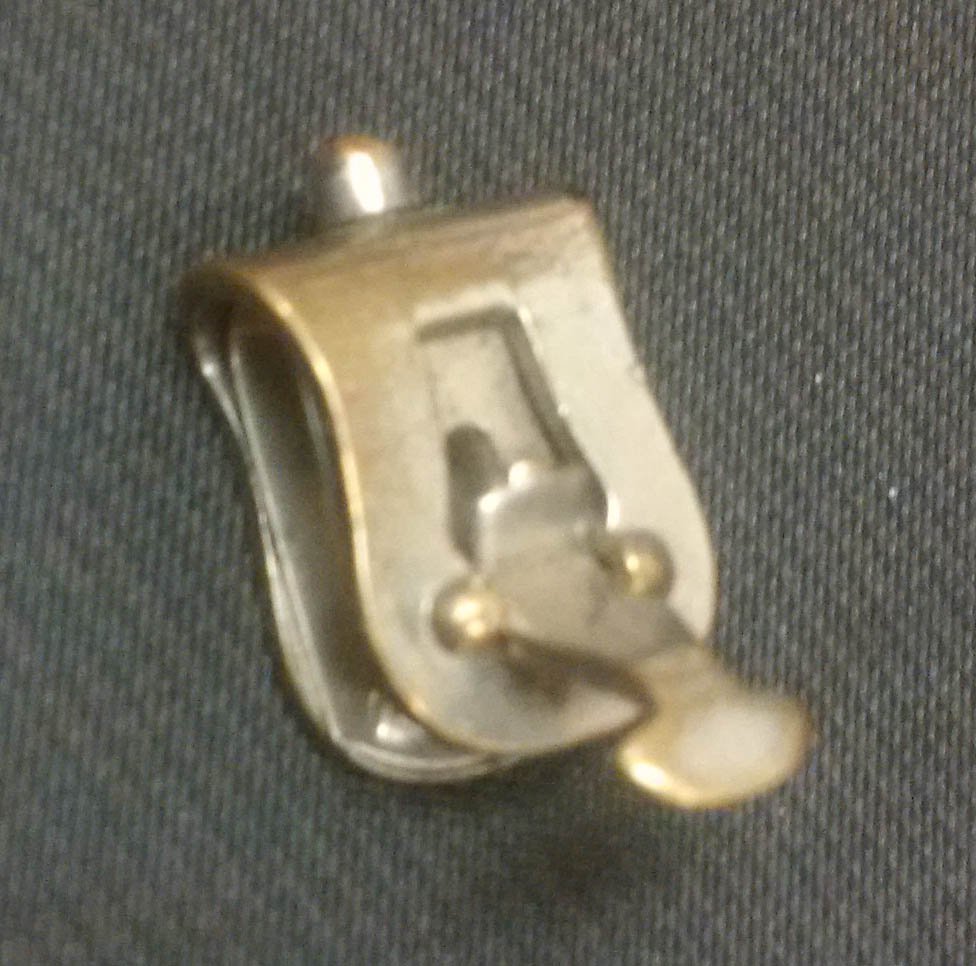 queensarchives's tweet photo. We found this beautiful #fastener the other day while #archivalprocessing which turns out to be the #reuse / #recycling of a broken vintage Washburne Bull-dog Grip meant to hold #shirtcuffs in place. Apparently also useful for cheating at cards! #aceupmysleeve https://t.co/imyjfxaQ1T