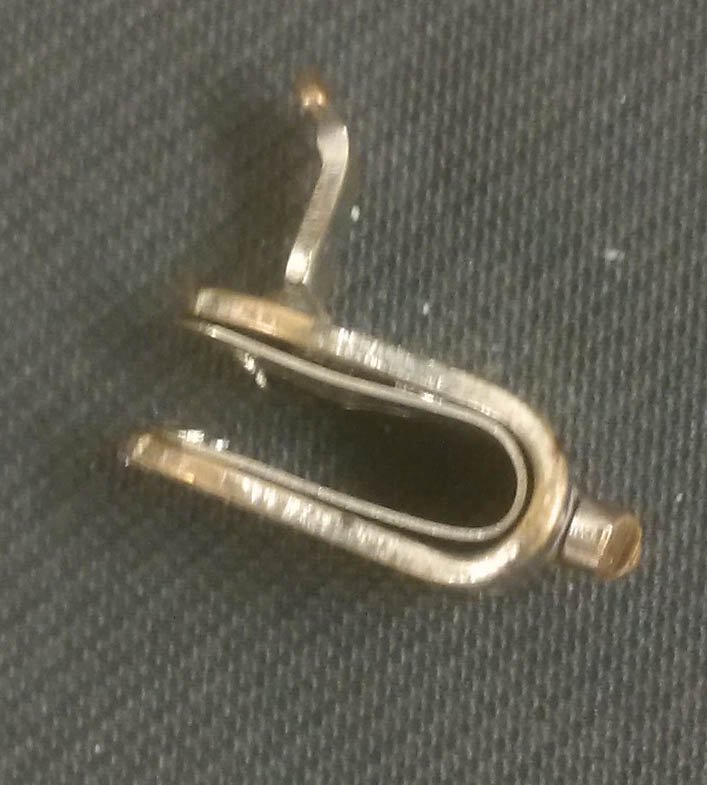 queensarchives's tweet photo. We found this beautiful #fastener the other day while #archivalprocessing which turns out to be the #reuse / #recycling of a broken vintage Washburne Bull-dog Grip meant to hold #shirtcuffs in place. Apparently also useful for cheating at cards! #aceupmysleeve https://t.co/imyjfxaQ1T