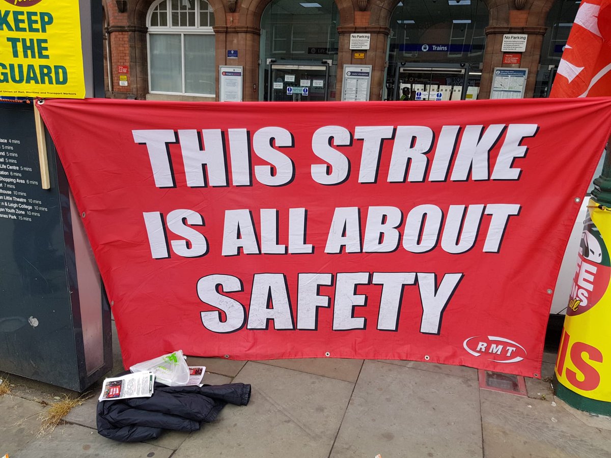 CllrDraper's tweet photo. Out supporting @RMTunion with youth officer @mattdawber1 On the picket line this morning at Wigan Wallgate to #keeptheguardonthetrain @transportgovuk 
@ChrisGraylingMP 
@MickCashRMT_GS 
To protect the public
@AndyBurnhamGM
Please let's find a solution. https://t.co/yExcAmp1yy