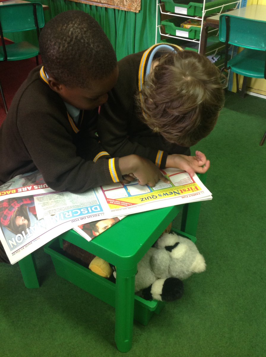 Our year 1 children enjoying their new 'first news' newspaper!