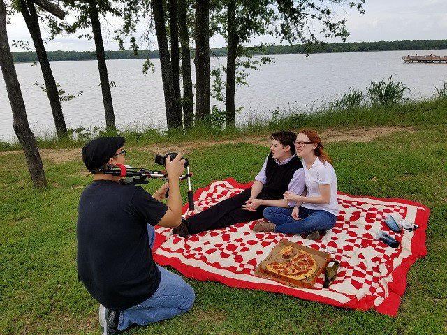 exitbagmovie's tweet image. Shooting the picnic scene for The Exit Bag. Director/Cinematographer Juan Espinosa (black cap) films as Austen Naron and Katharine Marie Wiebe act out the scene.