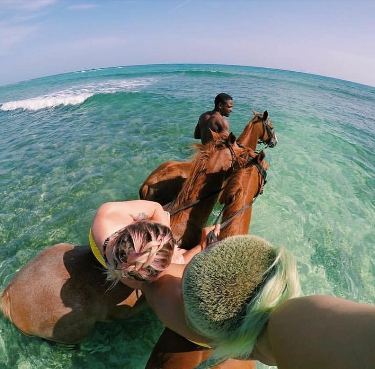 HalfMoonJamaica's tweet photo. We are spending the #firstdayofsummer snuggled up during a horseback ride and swim in the #caribbeansea. That's a truly magical moment. https://t.co/nGfdvuvh8o