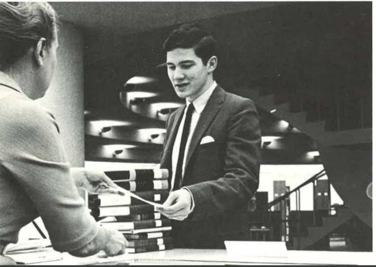 ORULibrary's tweet photo. #TBT This 1967 history major checks out his books at the circulation desk assisted by a friendly librarian. Although the technologies have changed and the number of books has increased ten-fold,  our wonderful librarians continue to be there to serve our incredible ORU students. https://t.co/Spr0KIrHUl