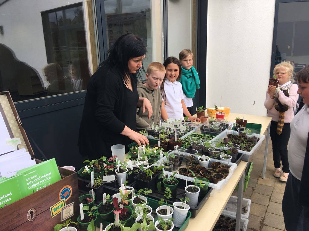 ManorParkSch's tweet photo. @mrsbanksmp Developing our community links and sharing our learning. Sustainability Club and P6s were given away free plants today. #ourcommunity #betterworld #seed2feed https://t.co/AP6MNOlcjf