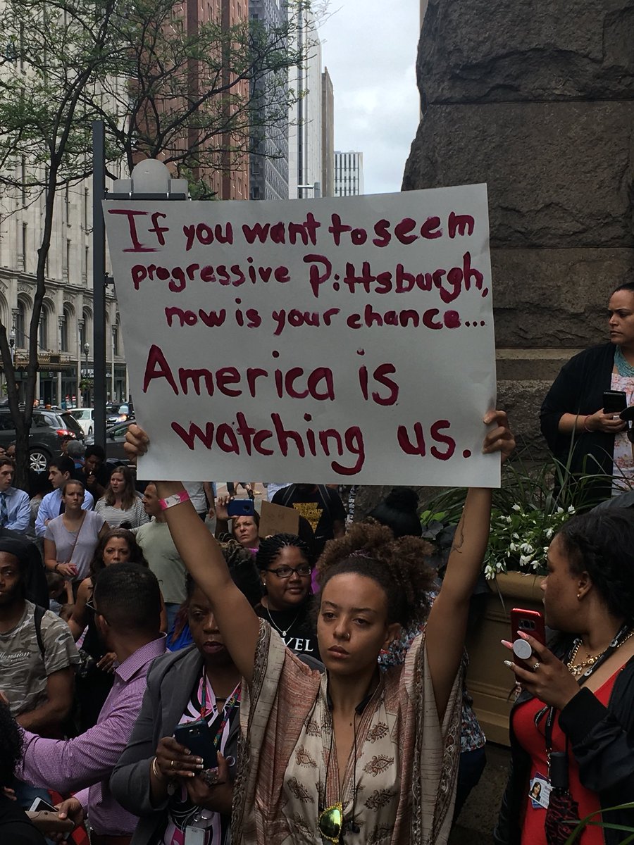 This sign reads: “America is watching us.”