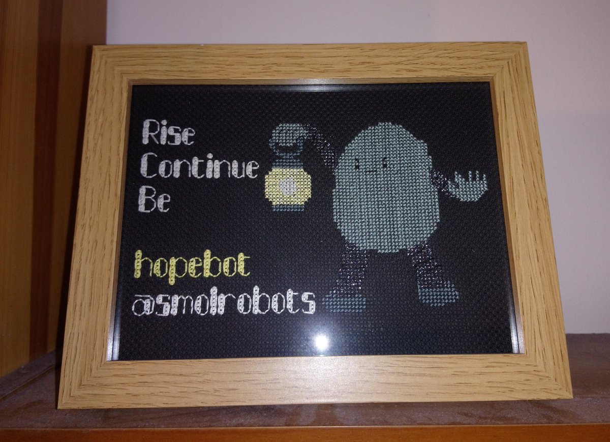 InnerTigger's tweet photo. Finished #crossstitch hopebot by @smolrobots not sure the glow-in-the-dark thread works or if you can tell it's limbs are shiny but over all I think it's worked better than I thought https://t.co/EfP2IvxHGy