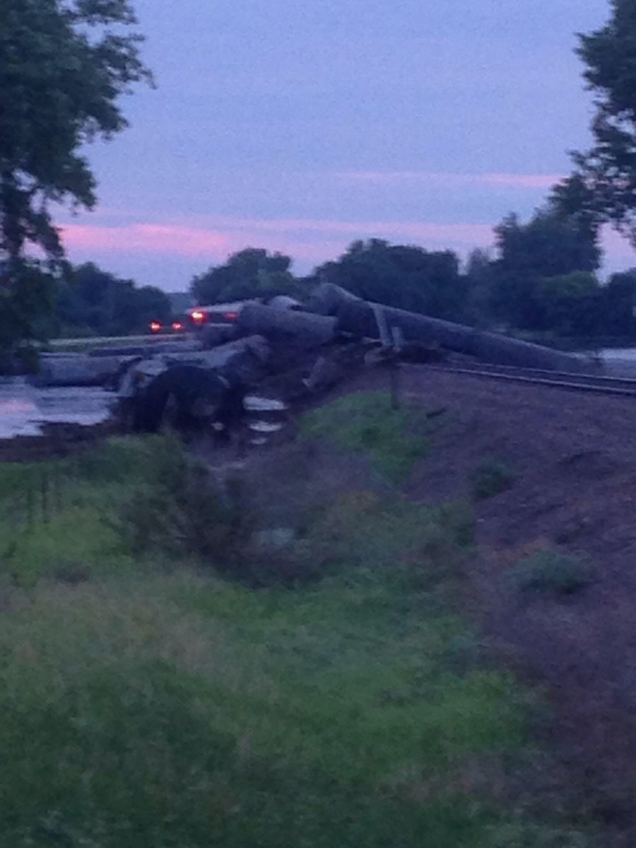 BartmanFarms's tweet photo. Train derailment by Doon, Iowa... what a disaster.... tankers full of oil spilling into flood waters.. pictures from @Jake_fabe https://t.co/BU6yI6JYQI
