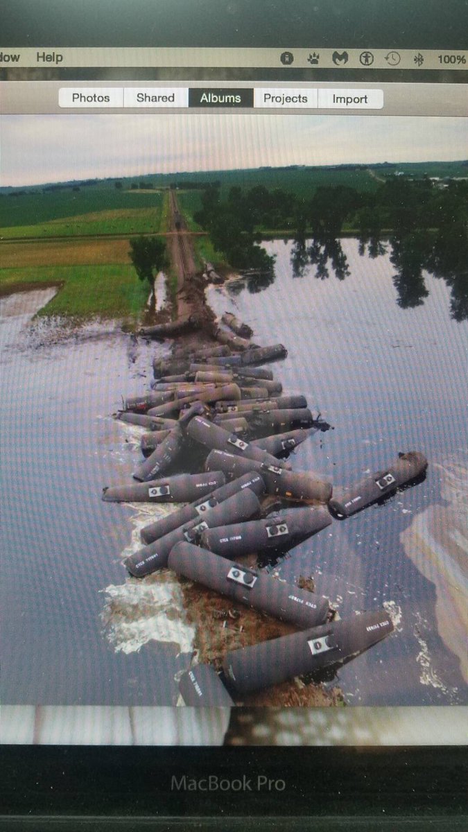 BartmanFarms's tweet photo. Train derailment by Doon, Iowa... what a disaster.... tankers full of oil spilling into flood waters.. pictures from @Jake_fabe https://t.co/BU6yI6JYQI