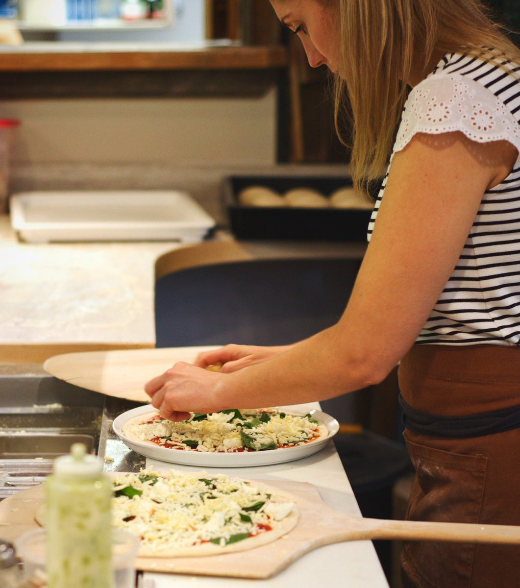 Co-Owner Meagan shows us how it's done the @stokedwoodfiredpizzeria way!
• 
Each and every pie is hand-stretched and topped to perfection before getting baked in the beautiful wood-burning oven they had brought in from California specially for their pizzeria
