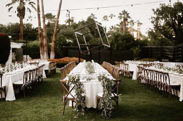 Bistro ighting, lush greenery and wooden vineyard chairs make the perfect additions to this outdoor reception. || Planning + Design: <a href="/therheefined/">Rheefined Company</a> | Photographer: <a href="/laurenscotti/">lauren scotti</a> | Florals: @thebloomingypsy | Rentals: @signaturepartyrentals || #PartySlate #PartySlatePro