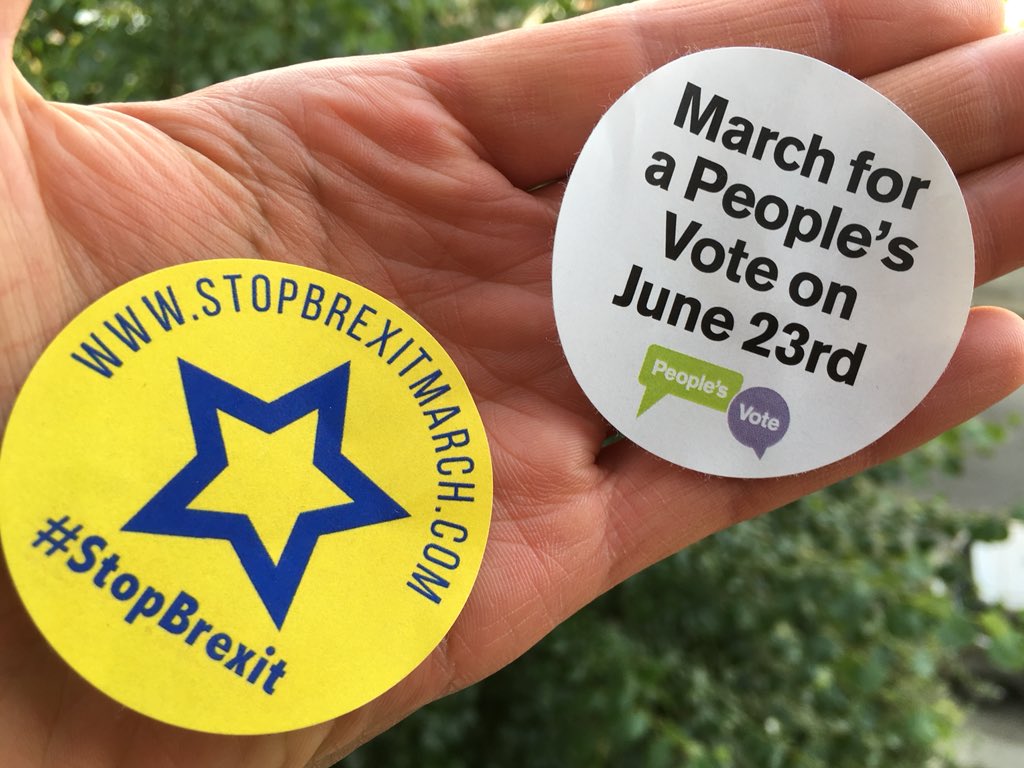 London, 23rd June #PeoplesVoteMarch to demand a vote on the final Brexit deal - people stick march stickers on the door of the #UKcabinetoffice