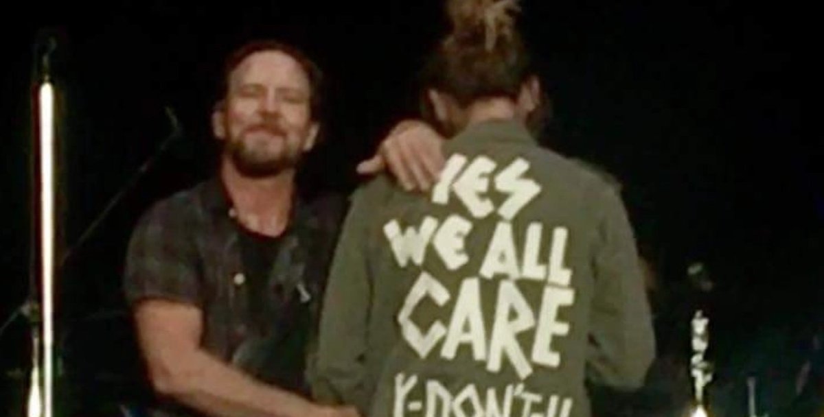 openculture's tweet photo. Eddie Vedder’s wife wears “Yes We All Care. Y Don’t U?” jacket at Pearl Jam concert https://t.co/IrqcXhYNxn https://t.co/coUWjsE7bL