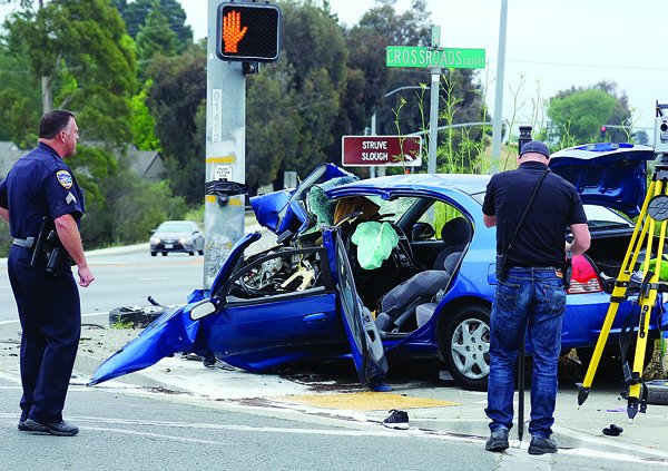 Watsonville Police collect evidence at the scene of a fatal crash early Sunday morning on Main Street where a 19-year-old Watsonville man died.  The Hyundai Elantra veered off the road and hit a pole at Crossroads Square.
