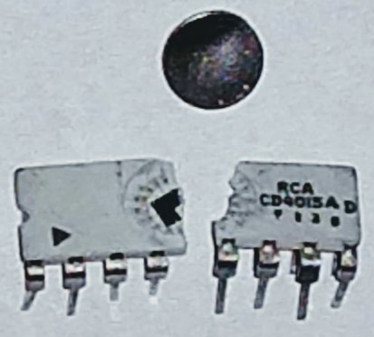 An old integrated circuit, accidentally snapped in half while trying to remove the circular lid to view the silicon die.
