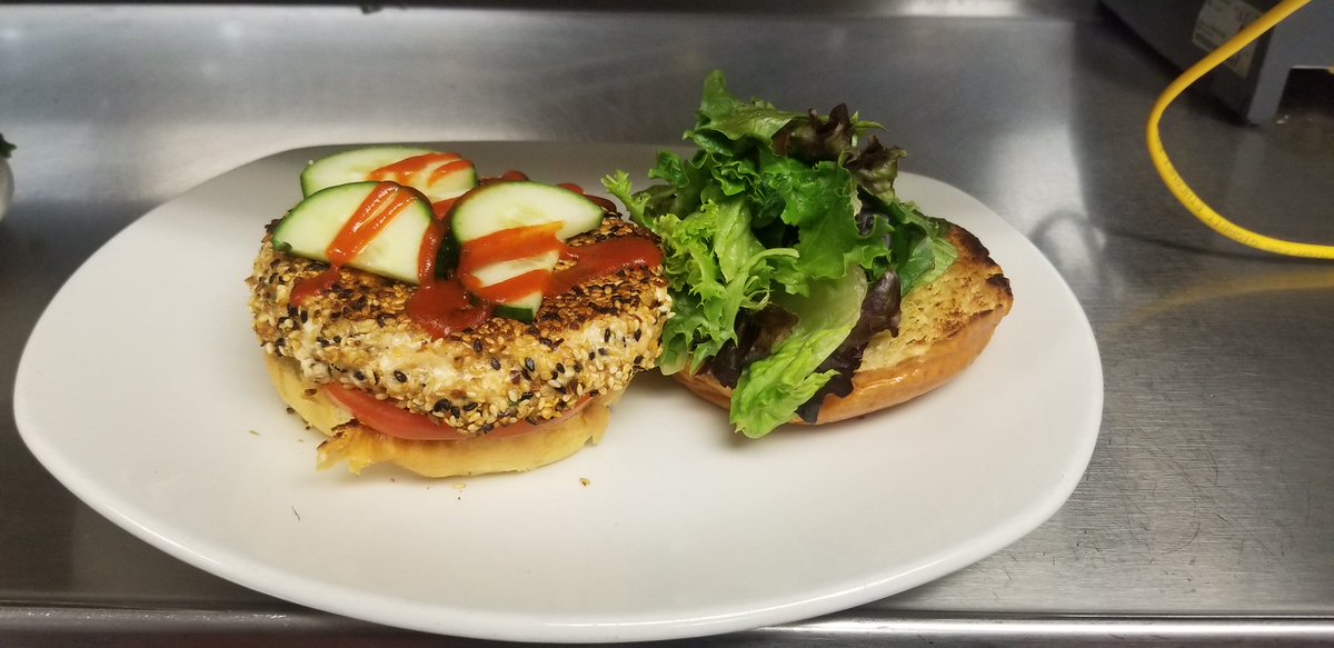 This special will be on the menu for the next couple of days... 😲👀 Our sesame-ginger seared #SalmonBurger—prepared in-house with spring mix, tomato, cucumber and sriracha on a brioche bun. #NomNom