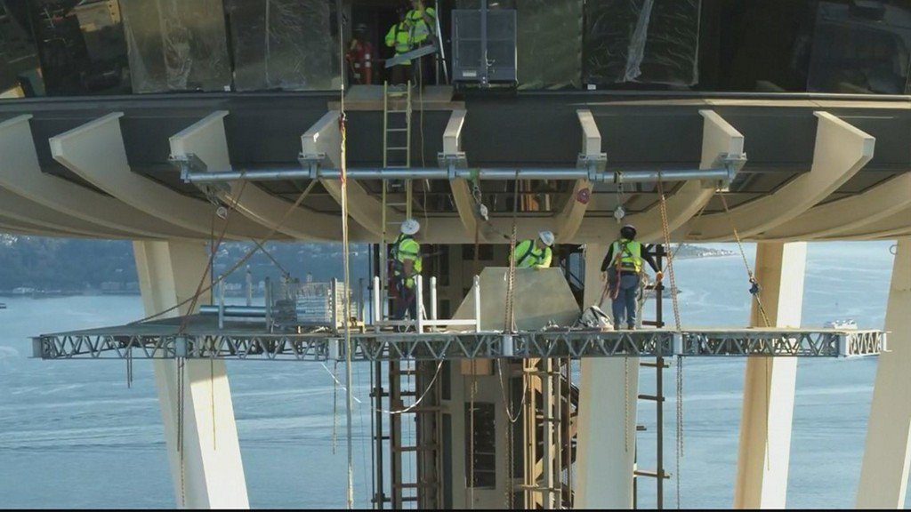 KING5Seattle's tweet photo. Drone video released by the Space Needle shows crews removing the last section of the elevated platform needed to install the rotating glass floor. https://t.co/FOQe9jPQe2 https://t.co/NdPKNnUBru