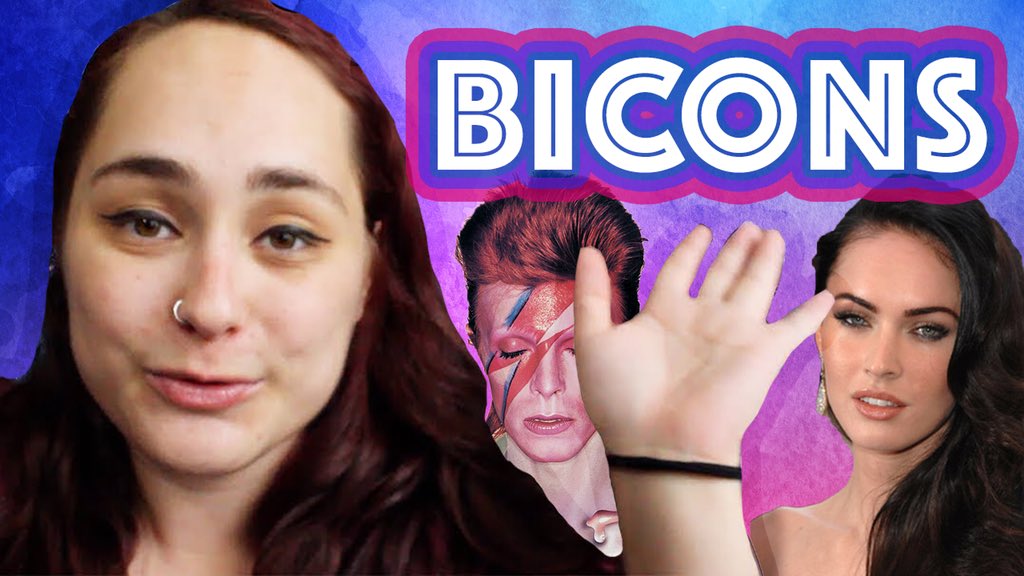 Paige holding up her hand, her mouth open mid-word; she is front of a purple, blue, and pink watercolor background, with pictures of Megan Fox and David Bowie behind her, and text that reads “BICONS” with the bi flag colors outlined around the letters.