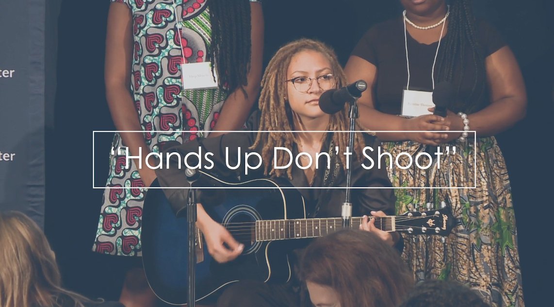 pulitzercenter's tweet photo. Indigo Passariello's performance of "Hands Up Don't Shoot" sent a powerful message about race and police violence at this year's #BeyondWar conference. https://t.co/V3EUX1oEv9 https://t.co/W6s69q3HoT