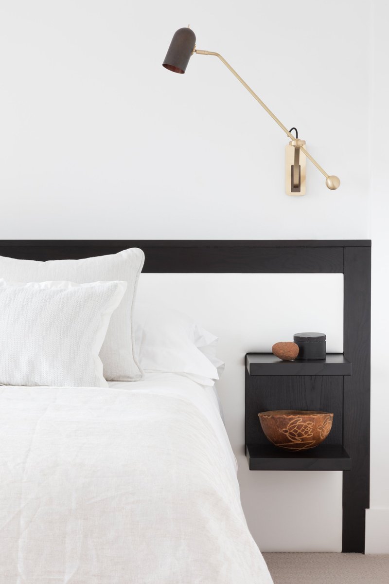 Floating side tables on this bespoke leather headboard ensure a functional guest room but with no loss of floor area. 

Spatial &amp; Interior Design and Project Management by Pippa Paton Design
Photo by Paul Craig