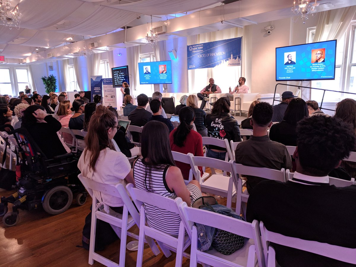 Anish and Wayne on stage of TechInclusion talking about being a "Woke CEO" in society today.
