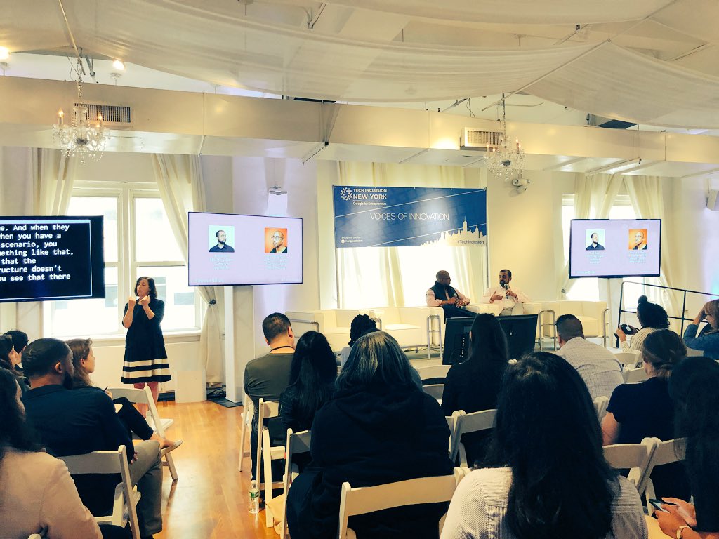 Wayne and Anil on stage, people watching