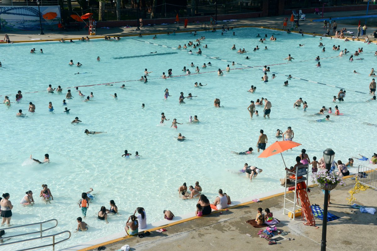 Guests swim and play in the outdoor pool at Astoria Park.