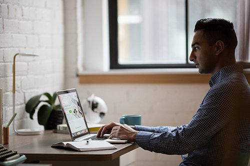 a man looking at a computer doing research