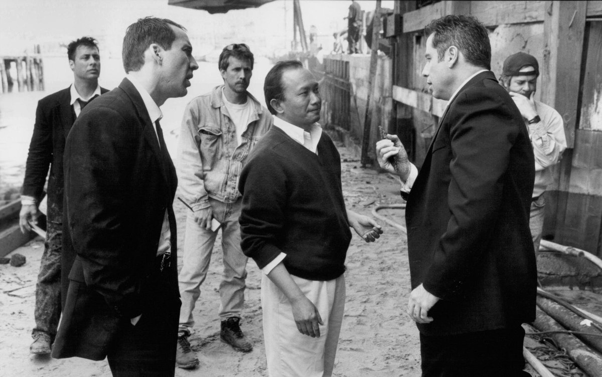 Nicolas Cage, John Woo, and John Travolta on the set of Face/Off