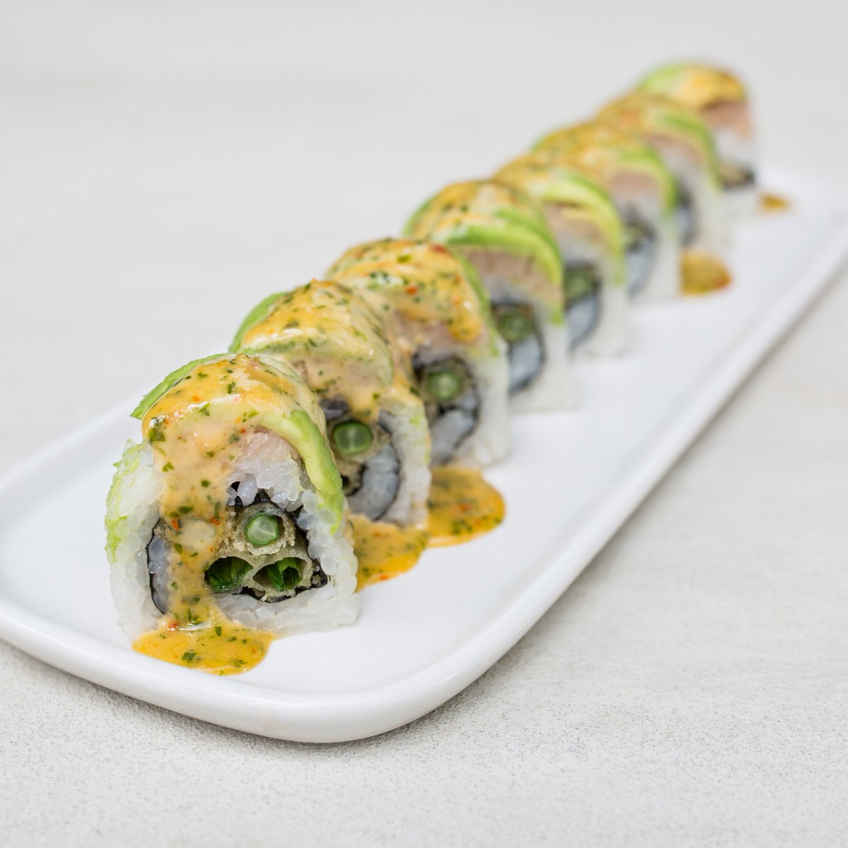 Bamboo Sushi on X: One of your favorites — The Green Machine. This roll  has tempura fried long beans and green onions with avocado & cilantro sweet  chile aioli on top! Get