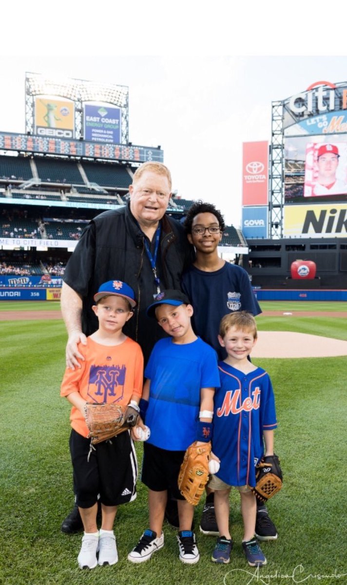 Picture of Rusty Staub posing with kids at CitiField