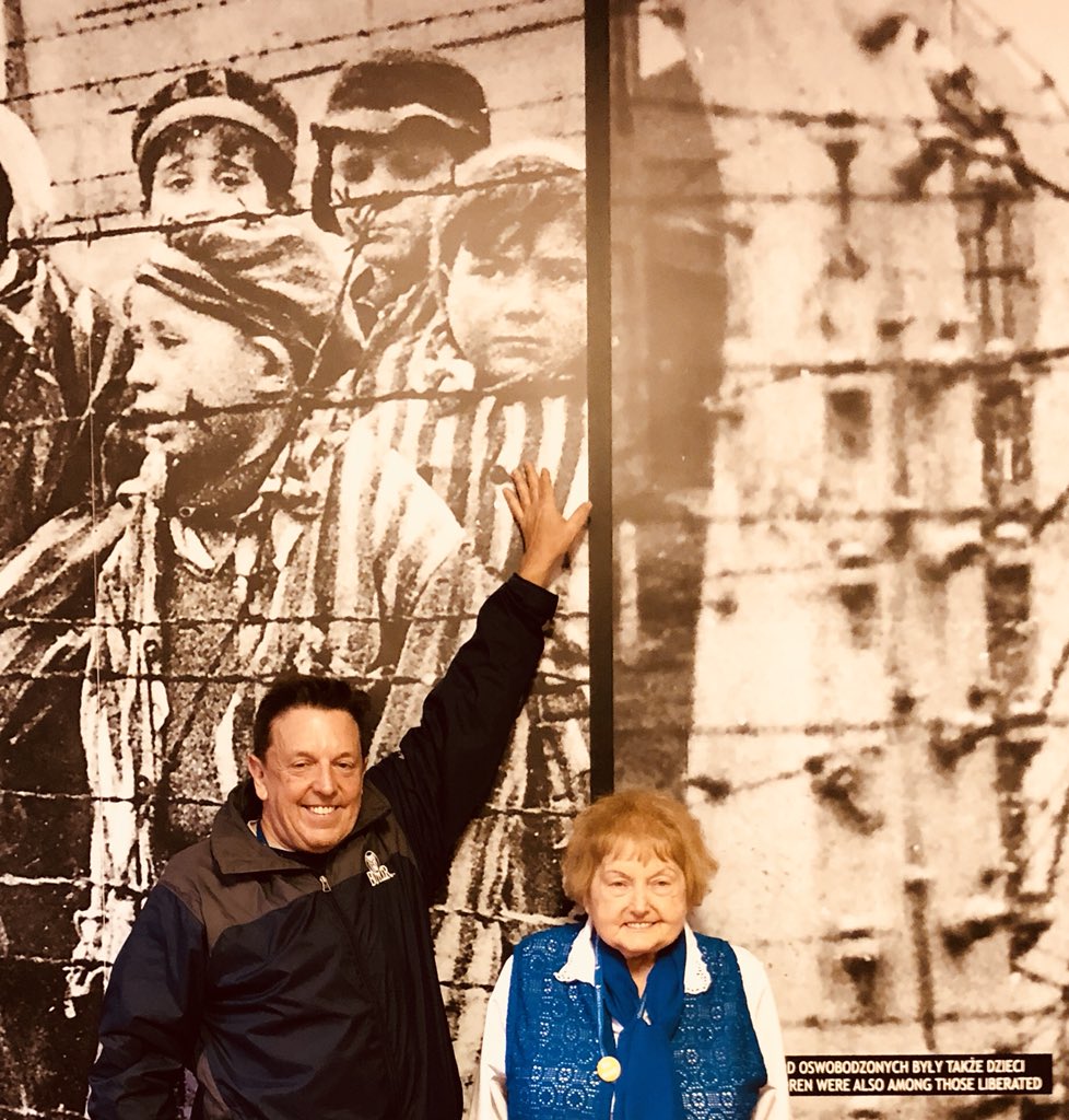 Today 6-28-18 in Auschwitz standing with my son, Alex Kor by one of the wall size pictures of our liberation 73 years Argo  my son is pointing to me.