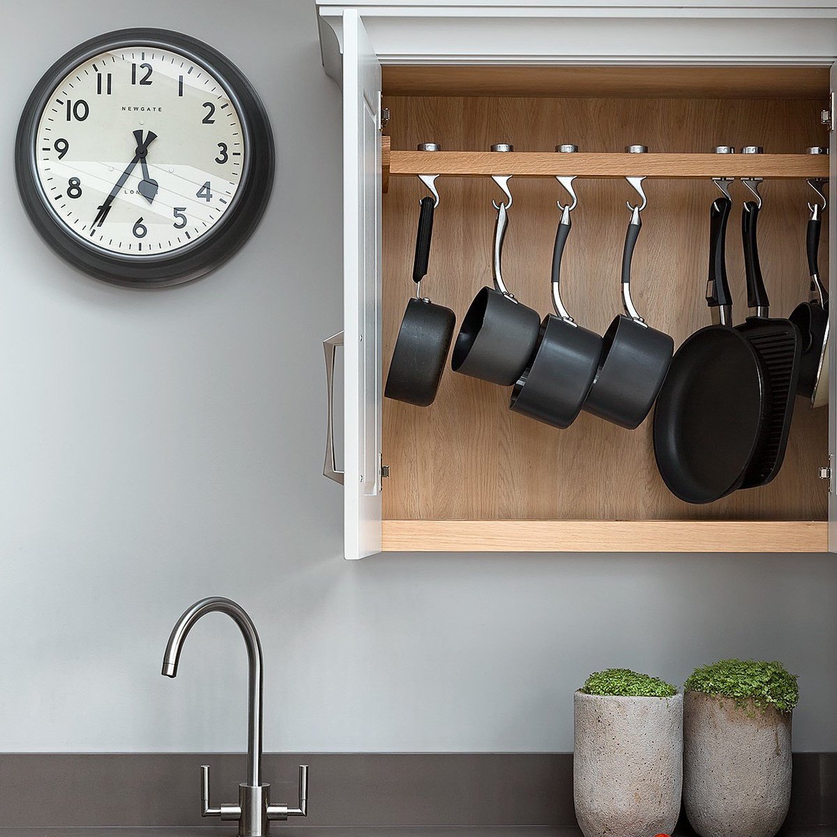 A place for everything! When we worked through the brief for the bespoke kitchen design in this project having these pots near to hand was critical for this client, so this pot hanging cupboard was developed. This kitchen also boasts a secret location for a Belling warmer!