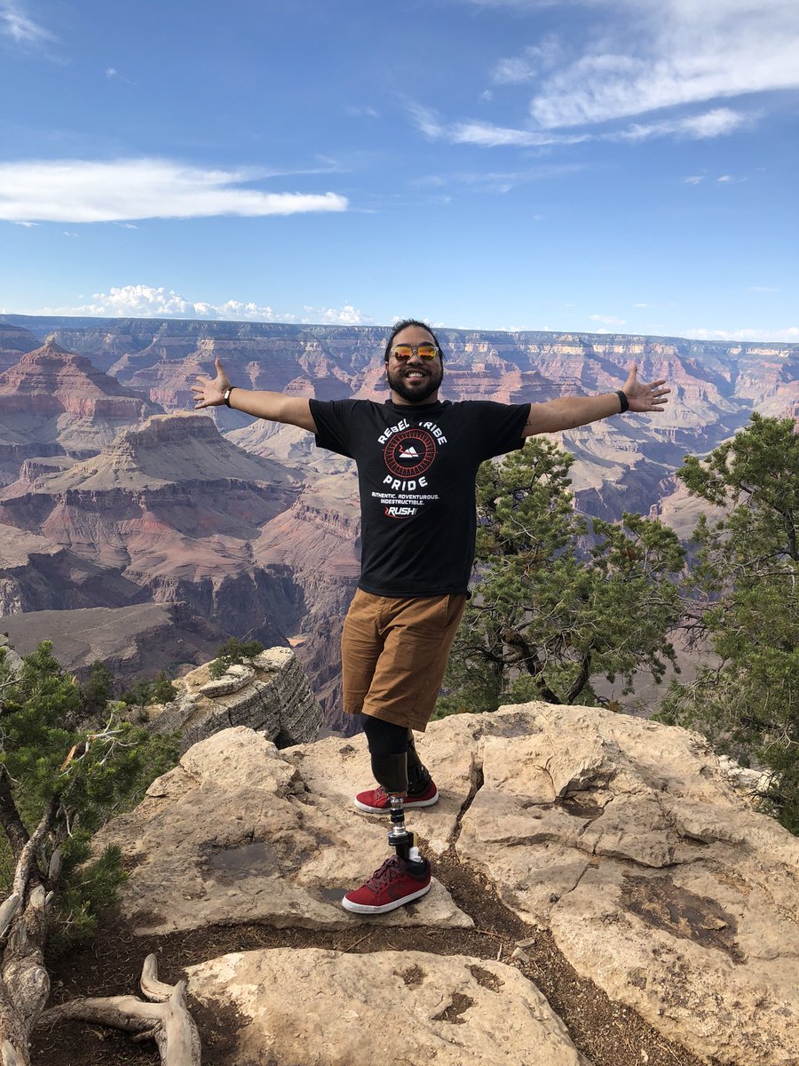 Todd standing with his arms wide open. The background is the Grand Canyon.