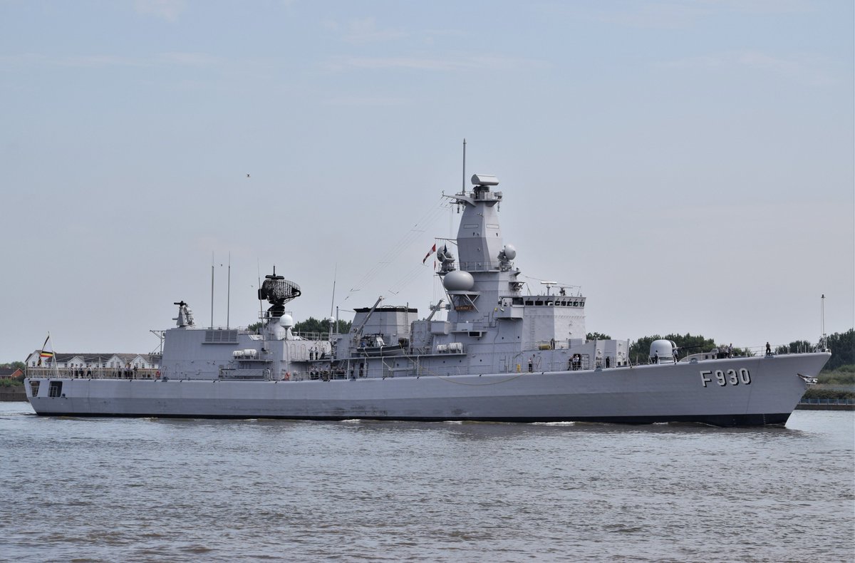 Belgian Navy Frigate heads up the Thames a grey ship on grey water against a white cloud sky - not much colour or contrast!
