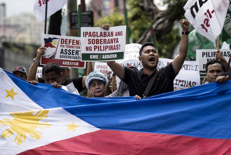 rapplerdotcom's tweet photo. Activists protest in front of the Chinese Consular office in Makati City on July 12, 2018, to mark the second anniversary of a UN-backed tribunal ruling in July 2016 saying there was no basis for China's claims to most of the South China Sea. Photo by Noel Celis/AFP #RStream https://t.co/zqMMIvY67w