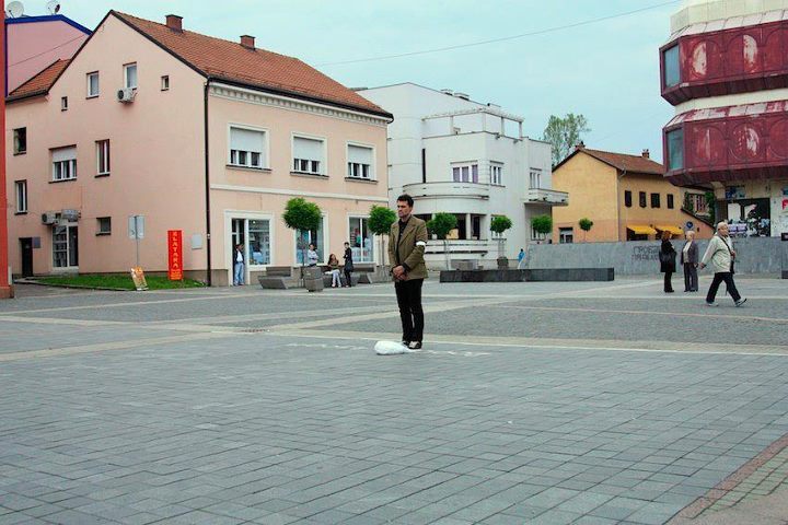 Emir Hodzic, whose brother & father were inmates of the Omarska concentration camp, was denied a visit to Omarska by the ArcelorMittal guards on 23 May 2012. The white body bag in front of him symbolizes the crimes committed against women in Prijedor.