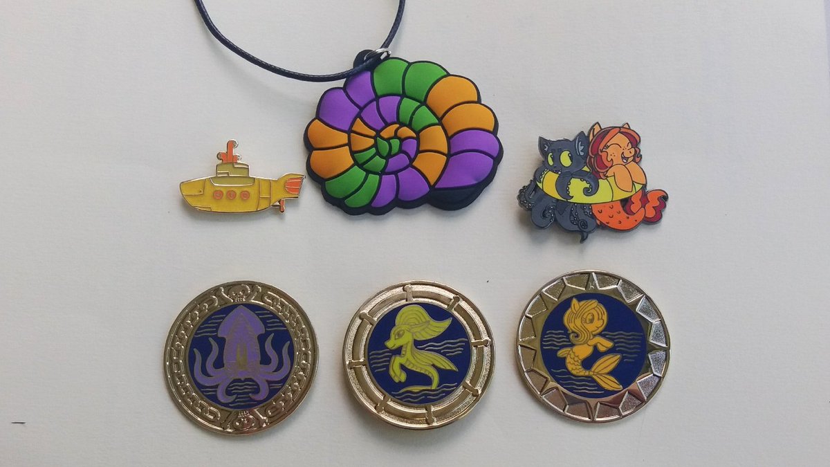 Next up in awesomeness today con merch!

The top row is:
• Yellow Submarine -  con staff &amp; guest pin
• Magical Shell Necklace - Sponsor Exclusive 
• 2018 Official TrotCon pin

The bottom row is our faction pins. They were designed by <a href="/TransformARTive/">Choco Bash ❂ @ FWA A14 Dealers Den</a>