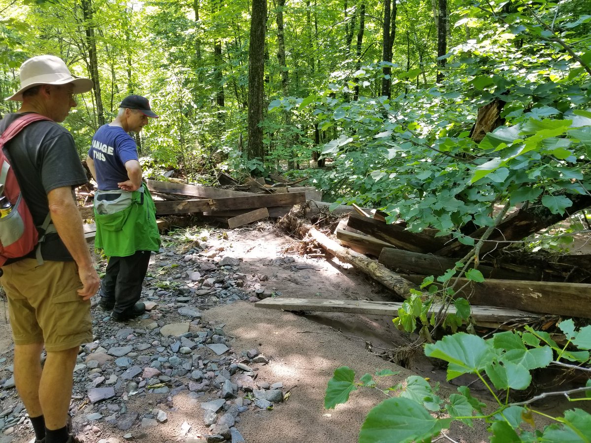 UPTreefarmer's tweet photo. Out at Maasto Hiihto with Mark and John reviewing damage in the Swedetown Creek Gorge and contemplating potential repair and re-route options...here we find the middle bridge some 200 feet downstream! @KNSC_Hancock #MaastoHiihto #Keweenaw #PureMichigan #CCStrong #MDEQ https://t.co/iAfbytAEJ7