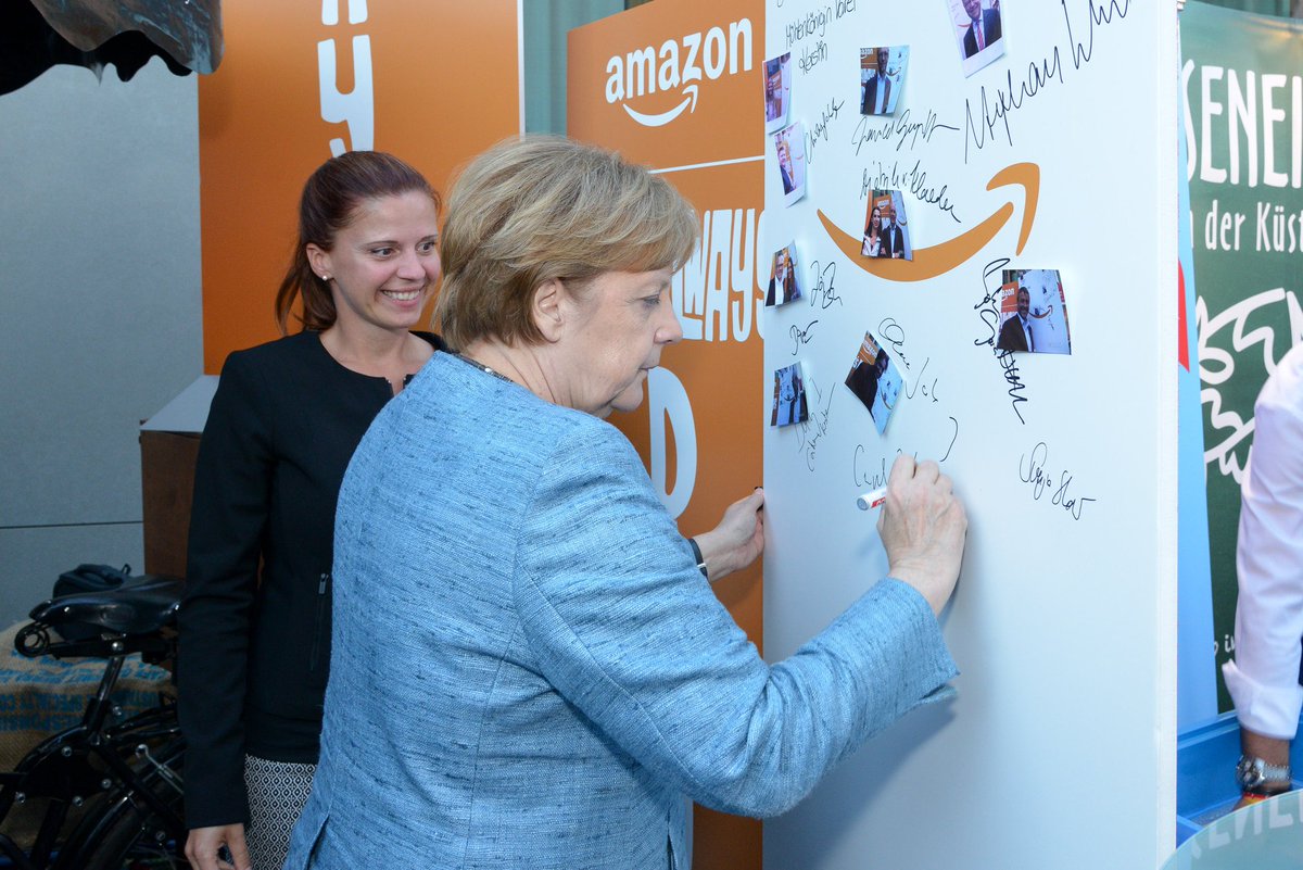 AmazonNewsEU's tweet photo. Sharing Amazon Philosophy “It’s Always Day 1” with Chancellor Angela #Merkel at political summer festival in Berlin #Day1 - https://t.co/EQCVaRmmwo https://t.co/SffQfmMzUx