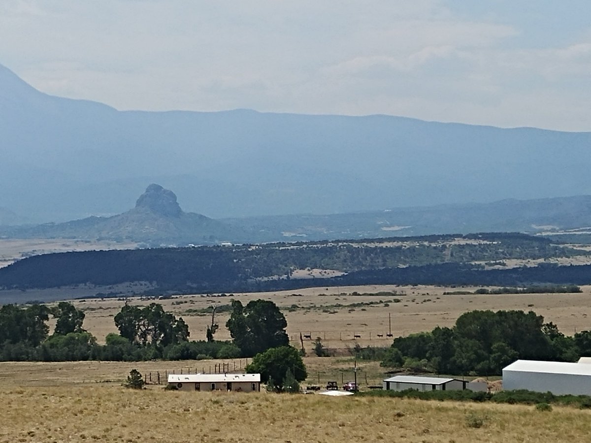 SamKraemerTV's tweet photo. And here's a look to the #SouthSpringFire toward Raspberry Mountain. Smoke is sitting in the valleys today. From the naked eye, I can really see the difference between trees that are still green &amp; those that aren't. #SpringFire @KOAA https://t.co/UYWisXRn1o