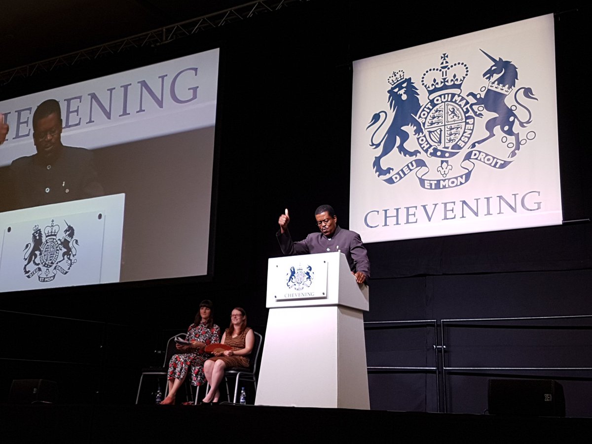 CheveningFCDO's tweet photo. Chevening Alumnus and Saint Kitts and Nevis High Commissioner to the UK @drkmisaac reads the winning poem in this year's Poet Laureate competition. Congratulations to the winner @Dexilirium! #CheveningMemories https://t.co/fLPjZeNvaL