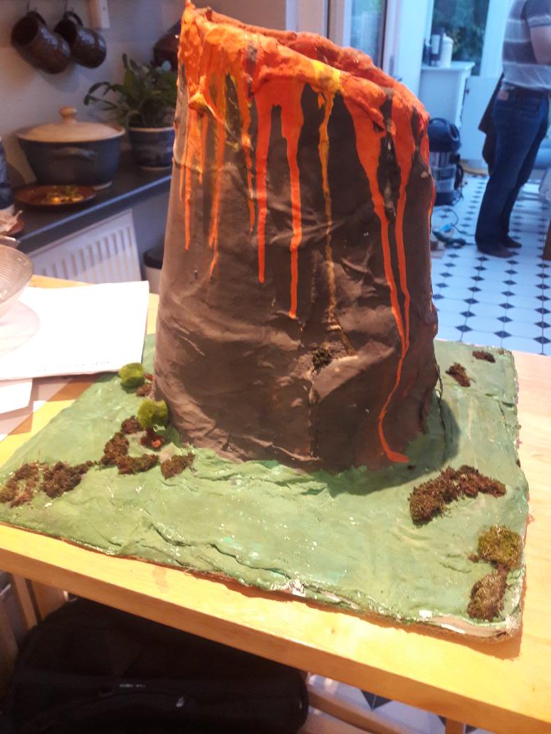 ChancelCat's tweet photo. My eldest brought home the volcano she made with friends at school today. Apparently they had to draw straws for who would get it and she "won". It's a great volcano. I'm very proud. But wtf do I do with it? As you can see, it's massive. https://t.co/H28iBUYyuE