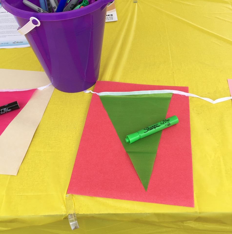 #Community #ArtProject? Find <a href="/CollideCF/">COLLIDE</a> set up near the amphitheater with their "Flags of Celebration" Project. These will be displayed later for all the community to see! Made possible by #RonaldMcDonaldHouse Charities of Northeastern #Ohio. #DTCFalls #FunFlowHere #FallsFriday