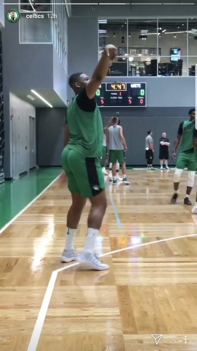 Boston Celtics forward Guerschon Yabusele talks in a hallway at